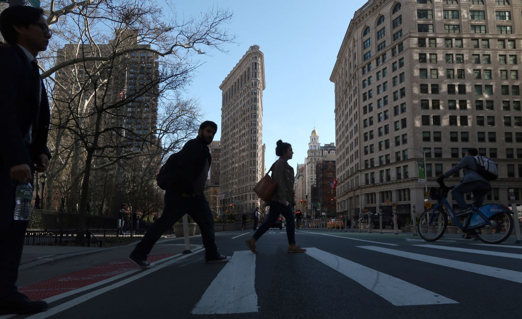 NEW YORK, NY - APRIL 23: A man crosses Fifth Avenue in front of the Flatiron Building on April 23, 2018 in New York City. (Photo by Gary Hershorn/Getty Images)