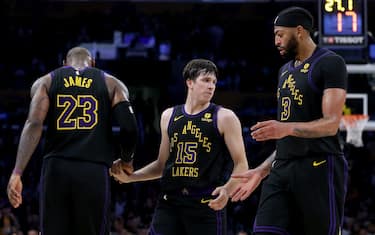 LOS ANGELES, CALIFORNIA - DECEMBER 18: Austin Reaves #15 of the Los Angeles Lakers is helped up by LeBron James #23 and Anthony Davis #3 during a 114-109 loss to the New York Knicks at Crypto.com Arena on December 18, 2023 in Los Angeles, California. NOTE TO USER: User expressly acknowledges and agrees that, by downloading and or using this photograph, User is consenting to the terms and conditions of the Getty Images License Agreement. (Photo by Harry How/Getty Images)
