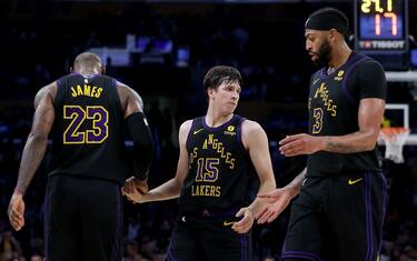 LOS ANGELES, CALIFORNIA - DECEMBER 18: Austin Reaves #15 of the Los Angeles Lakers is helped up by LeBron James #23 and Anthony Davis #3 during a 114-109 loss to the New York Knicks at Crypto.com Arena on December 18, 2023 in Los Angeles, California. NOTE TO USER: User expressly acknowledges and agrees that, by downloading and or using this photograph, User is consenting to the terms and conditions of the Getty Images License Agreement. (Photo by Harry How/Getty Images)