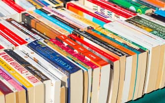 Paperback books for sale on market stall, UK
