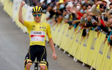 Team UAE Emirates' Tadej Pogacar of Slovenia wearing the overall leader's yellow jersey  celebrates as he crosses the finish line during the 18th stage of the 108th edition of the Tour de France cycling race, 129 km between Pau and Luz Ardiden, on July 15, 2021. (Photo by Thomas SAMSON / AFP) (Photo by THOMAS SAMSON/AFP via Getty Images)