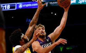 LOS ANGELES, CALIFORNIA - NOVEMBER 15:  Domantas Sabonis #10 of the Sacramento Kings takes a shot against Anthony Davis #3 of the Los Angeles Lakers in the second quarter at Crypto.com Arena on November 15, 2023 in Los Angeles, California.  NOTE TO USER: User expressly acknowledges and agrees that, by downloading and/or using this photograph, user is consenting to the terms and conditions of the Getty Images License Agreement. (Photo by Ronald Martinez/Getty Images)