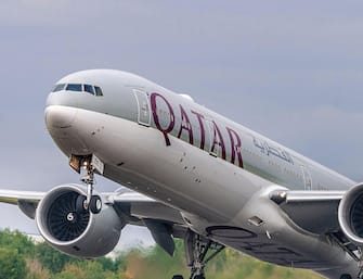 Qatar Airways Boeing 777-300/ER registration A7-BEK takes off at Manchester airport.