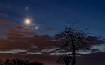 epa10484261 Planet Jupiter, the Moon (C) and planet Venus (R) observed on the sky photographed near Salgotarjan, Hungary, late 22 February 2023.  EPA/Peter Komka HUNGARY OUT