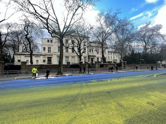 A Ukrainian flag painted on the road outside the Russian embassy in London by protesters ahead of the anniversary of the invasion of Ukraine on Friday. Picture date: Thursday February 23, 2023. (Photo by Jane Barlow/PA Images via Getty Images)