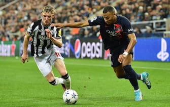 epa10900548 Anthony Gordon (L) of Newcastle in action against Kylian Mbappe of PSG during the UEFA Champions League Group F match between Newcastle United and Paris Saint-Germain in Newcastle, Britain, 04 October 2023.  EPA/PETER POWELL