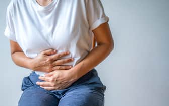 woman with stomach ache, menstrual period cramp, abdominal pain, food poisoning