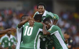 epa03566810 Ogenyi Onazi of Nigeria  jumps onto Sunday Mba of Nigeria after the second goal was scored during the 2013 Orange Africa Cup of Nations Quarterfinal football match between Ivory Coast and Nigeria at the Royal Bafokeng Stadium in Rustenburg, South Africa, 03 February 2013.  EPA/BARRY ALDWORTH