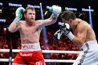 LAS VEGAS, NEVADA - SEPTEMBER 17: Canelo Alvarez (red trunks) and Gennadiy Golovkin (white trunks) exchange punches in the fight for the Super Middleweight Title at T-Mobile Arena on September 17, 2022 in Las Vegas, Nevada. (Photo by Sarah Stier/Getty Images)