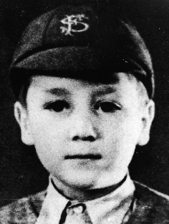 Headshot portrait of British musician and songwriter John Lennon (1940 -1980), of the pop group The Beatles, as a young boy in a school uniform and cap, c. 1948. (Photo by Pictorial Press/Getty Images)