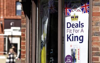A coronation advertisment on display in a shop near to Windsor Castle in Windsor, Berkshire. Preparations are underway across the UK for the coronation on May 6. Picture date: Thursday April 13, 2023.