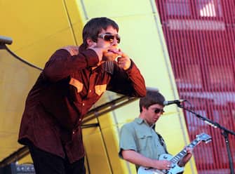 SAN FRANCISCO - 1997: Singer Liam Gallagher (L) and brother Noel Gallagher of band Oasis perform on stage in San Francisco supporting U2. (Photo by Dave Hogan/Getty Images)