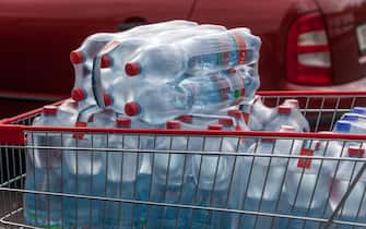 Bottled water, drinking water, plastic bottles in a shopping cart water bottles in