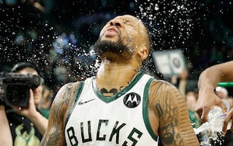 MILWAUKEE, WISCONSIN - JANUARY 14: Damian Lillard #0 of the Milwaukee Bucks reacts after getting water dumped over him celebrating his game winning shot against the Sacramento Kings at Fiserv Forum on January 14, 2024 in Milwaukee, Wisconsin. NOTE TO USER: User expressly acknowledges and agrees that, by downloading and or using this photograph, User is consenting to the terms and conditions of the Getty Images License Agreement. (Photo by John Fisher/Getty Images)