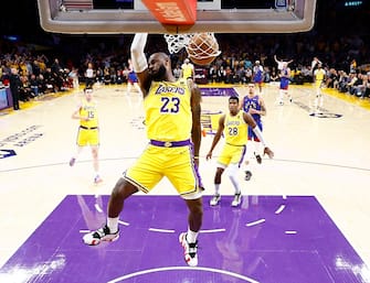 LOS ANGELES, CALIFORNIA - APRIL 25:  LeBron James #23 of the Los Angeles Lakers makes a slam dunk against the Denver Nuggets in the first quarter during game three of the Western Conference First Round Playoffs at Crypto.com Arena on April 25, 2024 in Los Angeles, California.  (Photo by Ronald Martinez/Getty Images)