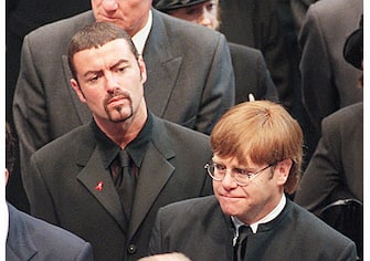 Pop stars George Michael (top) and Elton John leave Westminster Abbey after the funeral service 06 September of Diana Princess of Wales. The Princess was killed in a car crash in Paris 31 August. (Photo credit should read JOHNNY EGGITT/AFP via Getty Images)
