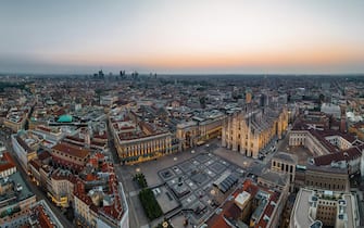 Aerial Drone Piazza del Duomo, Cathedral Square, with Milan Cathedral or Duomo di Milano during morning blue hour, Milan, Lombardia, Italy