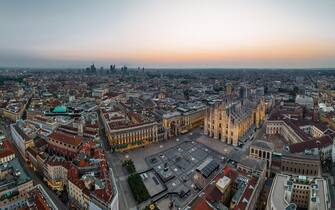 Aerial Drone Piazza del Duomo, Cathedral Square, with Milan Cathedral or Duomo di Milano during morning blue hour, Milan, Lombardia, Italy