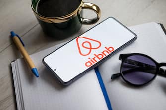 POLAND - 2024/01/31: In this photo illustration an Airbnb logo seen displayed on a smartphone. (Photo Illustration by Mateusz Slodkowski/SOPA Images/LightRocket via Getty Images)