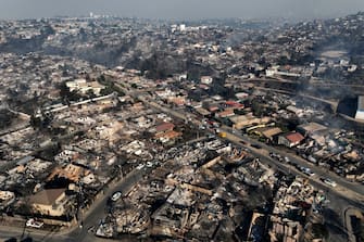 Aerial view of the aftermath of a fire at the hills in ViÃ±a del Mar, Chile on February 3, 2024. The region of Valparaoso and ViÃ±a del Mar, in central Chile, woke up on Saturday with a partial curfew to allow the movement of evacuees and the transfer of emergency equipment in the midst of a series of unprecedented fires, authorities reported. (Photo by Javier TORRES / AFP) (Photo by JAVIER TORRES/AFP via Getty Images)