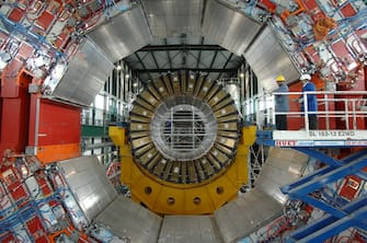 SWITZERLAND - JANUARY 25:  The Large Hadron Collider, Large Hadron Collider (LHC) is a particle accelerator which will probe deeper into matter than ever - This is the next step of CERN - The workers positioned one of the CMS magnet - The CMS is the largest superconducting solenoid magnet of the world has reached full field - Weighing over 10,000 tons, the magnet of the CMS Collaboration is built around a superconducting solenoid 6 meters in diameter and 13 meters in length - It produces a field of 4 Tesla, almost 100 000 times higher than that of the Earth, and stores an energy of 2.5 GJ, sufficient to melt 18 tons of gold in Geneve, Switzerland on January 25th, 2007.  (Photo by Lionel FLUSIN/Gamma-Rapho via Getty Images)