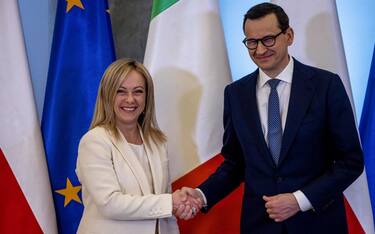 Polish Prime Minister Mateusz Morawiecki (R) shakes hands with Italian Prime Minister Giorgia Meloni during an official welcoming ceremony in Warsaw on February 20, 2023. (Photo by Wojtek RADWANSKI / AFP) (Photo by WOJTEK RADWANSKI/AFP via Getty Images)