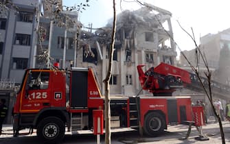 Rescue teams work outside a heavily damaged building, targeted by an Israeli strike in the Iranian capital Tehran on June 13, 2025. Israel carried out strikes against Iran early on June 13, targeting its nuclear and military sites as well as residential buildings in Tehran, after US President Donald Trump warned of a possible "massive conflict" in the region. (Photo by AFP)