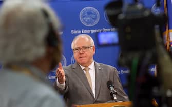 tim walz ST PAUL, MINNESOTA - JUNE 03: Minnesota Governor Tim Walz speaks to the press on June 3, 2020 in St. Paul, Minnesota. Earlier today the state's Attorney General Keith Ellison announced that charges of aiding and abetting second-degree murder and aiding and abetting second-degree manslaughter had been filed against former Minneapolis police officers Thomas Lane, J. Alexander Kueng, and Tou Thao in the death of George Floyd. Ellison also announced that charges against former officer Derek Chauvin were upgraded to second-degree murder. On May 25, Chauvin kneeled on Floyd's neck for nine minutes while detaining him on suspicion of trying to pass a counterfeit $20 bill. Floyd went unconscious and died at the scene. The other officer were part of the responding team. (Photo by Scott Olson/Getty Images)