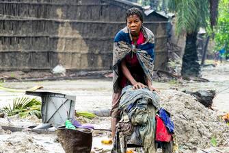 epa10521050 A woman recovers some clothes after the destruction caused by the storm Freddy in Quelimane, Mozambique, 13 March 2023. This is one of the longest lasting storms ever, after it formed at the beginning of February in the Asian seas, crossing the entire Indian Ocean to the east African coast.  EPA/ANDRÉ CATUEIRA