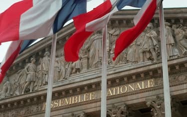 French flags fly in front of the Assemblee Nationale, a legislative building of the French government, Paris, France.