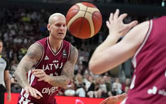 (240703) -- RIGA, July 3, 2024 Photo by Xinhua/ABACAPRESS.COM) -- Janis Timma of Latvia passes the ball during the FIBA Men's Olympic Qualifying Tournament 2024 group A match between Latvia and Georgia in Riga, Latvia, July 2, 2024. (Photo by Edijs Palens/Xinhua/ABACAPRESS.COM