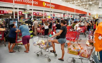 People buy provisions and non-perishable foods at a supermarket in preparation for the arrival of Hurricane Beryl in the tourist city of Cancun, Quintana Roo State, Mexico on July 2, 2024. Hurricane Beryl was hurtling towards Jamaica on July 2, as a monster Category 5 storm, after killing at least five people and causing widespread destruction in a deadly sweep across the southeastern Caribbean. (Photo by Elizabeth RUIZ / AFP) (Photo by ELIZABETH RUIZ/AFP via Getty Images)