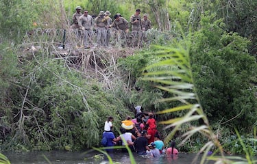 epa10621092 Soldiers observe migrants after crossing the Rio Grande to try to enter the United States, in Matamoros, Mexico, 10 May 2023 (issued 11 May 2023). On the last day of Title 42 policy, migrants have attempted to cross into the United States.  EPA/Abraham Pineda Jacome