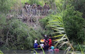 epa10621092 Soldiers observe migrants after crossing the Rio Grande to try to enter the United States, in Matamoros, Mexico, 10 May 2023 (issued 11 May 2023). On the last day of Title 42 policy, migrants have attempted to cross into the United States.  EPA/Abraham Pineda Jacome