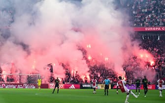 AMSTERDAM - Ajax supporters set off fireworks during the Dutch Eredivisie match between Ajax and Feyenoord at the Johan Cruijff ArenA on September 24, 2023 in Amsterdam, Netherlands. ANP OLAF KRAAK (Photo by ANP via Getty Images)