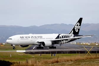 AUCKLAND, NEW ZEALAND - MARCH 16: An Air New Zealand plane is seen at Auckland Airport on March 16, 2020 in Auckland, New Zealand. Air New Zealand has announced it will reduce its international capacity by 85 per cent as a result of the current coronavirus pandemic and its impact on travel demand. The airline is suspending flights between Auckland and Chicago, San Francisco, Houston, Buenos Aires, Vancouver, Tokyo Narita, Honolulu, Denpasar and Taipei from 30 March to 30 June. It is also suspending its Londonâ  Los Angeles service from 20 March through to 30 June. Air New Zealand's Tasman and Pacific Island network capacity will significantly reduce between April and June, while domestic route capacity will be reduced by around 30 percent in April and May. (Photo by Hannah Peters/Getty Images)