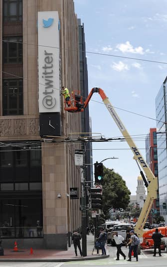 epa10766823 Workers remove letters from the iconic vertical Twitter sign at the company’s headquarters after Twitter owner Elon Musk annouced the rebranding of the social media platorm to X in San Francisco, California, USA, 24 July 2023. Work was halted due to San Francisco police responding to a call from building security that the signs were being stolen. A San Francisco police spokesperson stated that Twitter had a work order to take the sign down but didn’t communicate that to security and the property owner of the building.  EPA/JOHN G. MABANGLO
