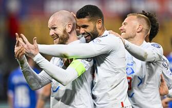 epa10544489 Iceland's Aron Gunnarsson (L) celebrates with his teammates after scoring the 0-5 goal for a hattrick during the UEFA Euro 2024 qualifying group J soccer match between Liechtenstein and Iceland, in Vaduz, Liechtenstein, 26 March 2023.  EPA/GIAN EHRENZELLER