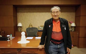 Michael Bambang Hartono, co-owner of Djarum Group, stands for a photograph following an interview in Jakarta, Indonesia, on Aug. 21, 2018. Hartono, the 78-year-old tycoon and professional bridge player, whose family fortune spans from tobacco to banking and telecom, is bidding to become Indonesia's oldest Asian Games medal winner.Â Photographer: Dimas Ardian/Bloomberg via Getty Images