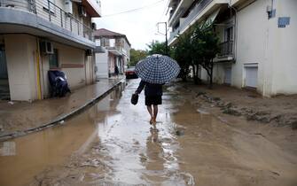 epa10843211 A man walks through a flooded road during the storm named Daniel in the area of Volos, Magnesia, Greece, 06 September 2023. The storm 'Daniel' sweeping through most of Greece with heavy rain and lightning caused extensive damage in the power network at Volos, Mt. Pilio, elsewhere in the Magnissia prefecture, as well as in the Sporades Islands.  EPA/YANNIS KOLESIDIS