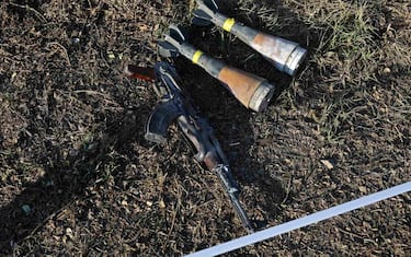 Weapons lie on the ground, a week after the October 7 attack by Palestinian Hamas militants on kibbutz Beeri near the border with Gaza, on October 14, 2023. Thousands of people, both Israeli and Palestinians have died since October 7, 2023, after Palestinian Hamas militants entered Israel in a surprise attack leading Israel to declare war on Hamas in the Gaza Strip enclave on October 8. (Photo by Thomas COEX / AFP) (Photo by THOMAS COEX/AFP via Getty Images)