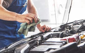 Auto mechanic working in garage. Repair service