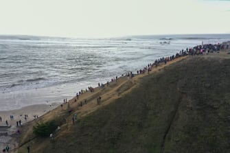 CALIFORNIA, USA - DECEMBER 28: Hundreds of people hike to trailhead to watch massive waves and surfers at Mavericks Beach of Half Moon Bay as high surf and coastal flood warning in California, United States on December 28, 2023. (Photo by Tayfun Coskun/Anadolu via Getty Images)