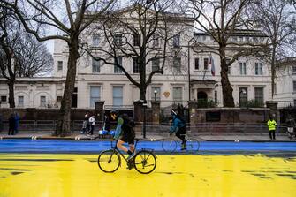 LONDON, ENGLAND - FEBRUARY 23: In this handout provided by Led By Donkeys, Activists from political campaign group Led By Donkeys, pour paint onto the road to create a giant Ukrainian flag outside the Russian Embassy on February 23, 2023 in London, England. The group created the flag using washable paint poured onto the road and then driven through by passing vehicles to show solidarity with Ukraine on the eve of the one year mark since the Russian invasion of Ukraine began. (Photo by Handout/Led By Donkeys via Getty Images)