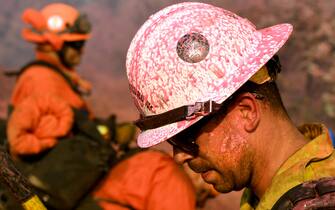 Los Angeles -CA-MAY 24, 2021: While covered in phos-chek San Bernardino National Forest firefighter Aaron Pittman takes a break from the Jurupa Valley Fire as it burns over 100-acres in Riverside Monday. (Wally Skalij / Los Angeles Times via Getty Images)