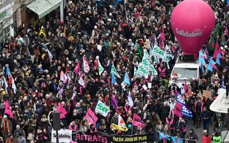 TOPSHOT - Members of the Solidaires trade unions group march  during a rally on a second day of nationwide strikes and protests over the government's proposed pension reform, in Paris on January 31, 2023. - France braces for major transport blockages, with mass strikes and protests set to hit the country for the second time in a month in objection to the planned boost of the age of retirement from 62 to 64. On January 19, some 1.1 million voiced their opposition to the proposed shake-up -- the largest protests since the last major round of pension reform in 2010. (Photo by JULIEN DE ROSA / AFP) (Photo by JULIEN DE ROSA/AFP via Getty Images)