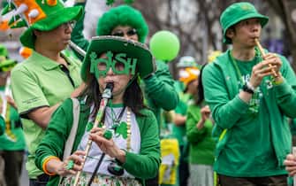 People take part in a St. Patrick's Day parade in Tokyo on March 17, 2024. (Photo by Yuichi YAMAZAKI / AFP)
