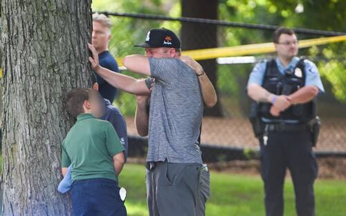 epa12327176 An adult and child take a moment while they leave the school as police respond to a shooting at the Annunciation Catholic School in Minneapolis, Minnesota, USA, 27 August 2025. According to police, two children and the gunman died and several were injured in the shooting at a Catholic primary church.  EPA/CRAIG LASSIG