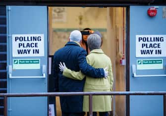 epa08064546 SNP leader Nicola Sturgeon (R) arrives to cast her vote with her husband Peter Murrell (L), during the general elections at Broomhouse Community Hall polling station, Glasgow, Britain, 12 December 2019. Britons go to the polls on 12 December 2019 in a general election to vote for a new parliament.  EPA/ROBERT PERRY