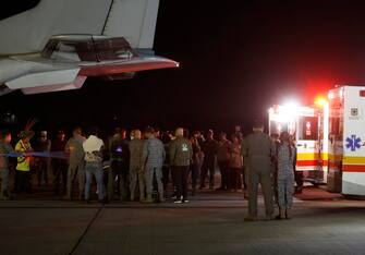 epa10682885 People and military personnel gather during an unload operation of four children who were missing after a plane crash, at the CATAM Military Airport in Bogota, Colombia, 10 June 2023, before being transferred to a military hospital. The four siblings, aged 13, nine, four and one, were found alive after surviving a plane crash on 01 May 2023 and spending weeks in Colombia's Amazon jungle. After their discovery, the children were treated by medics from the Special Operations Command deployed in the area and then transferred by helicopter to the military base of San Jose del Guaviare, capital of Guaviare, where 'they were stabilized'.  EPA/Mauricio Duenas Castaneda